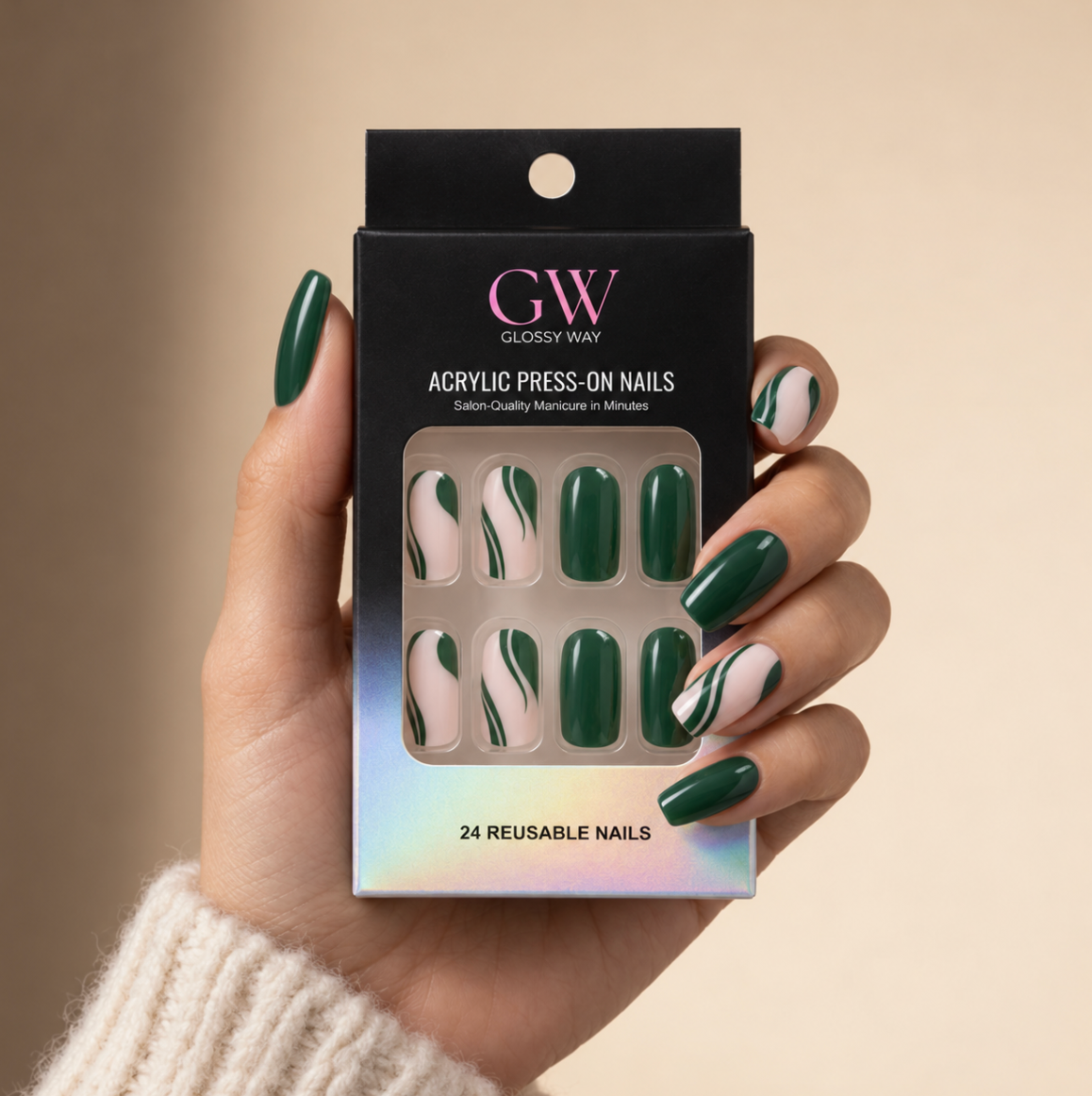A hand wearing glossy press-on nails in dark green and white swirl patterns, holding a black box of GW Glossy Way Acrylic Press-On Nails against a warm beige background.